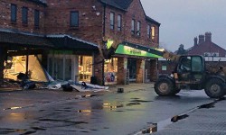Now that’s a hole in the wall… Thieves use digger to rip out cash machine