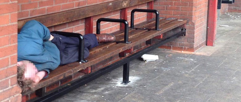 A man sleeps under the bars installed on a bench at a Rougier Street bus stop. Photograph: Jack Gevertz / YorkMix