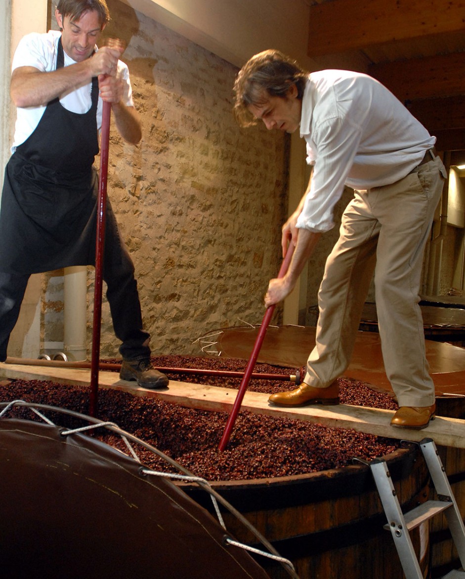 Walking the plank: Mike Tipping (right) getting hands on, atop a barrel of fermenting pinot noir grapes, in a Burgundian winery