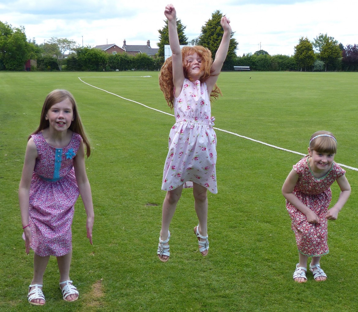 Lydia and Charlotte Unsworth and their friend Hannah are jumping for joy in their new dresses. Photographs: Kathryn Richardson