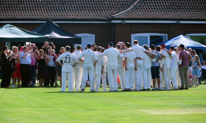 The teams pose for pictures after the match