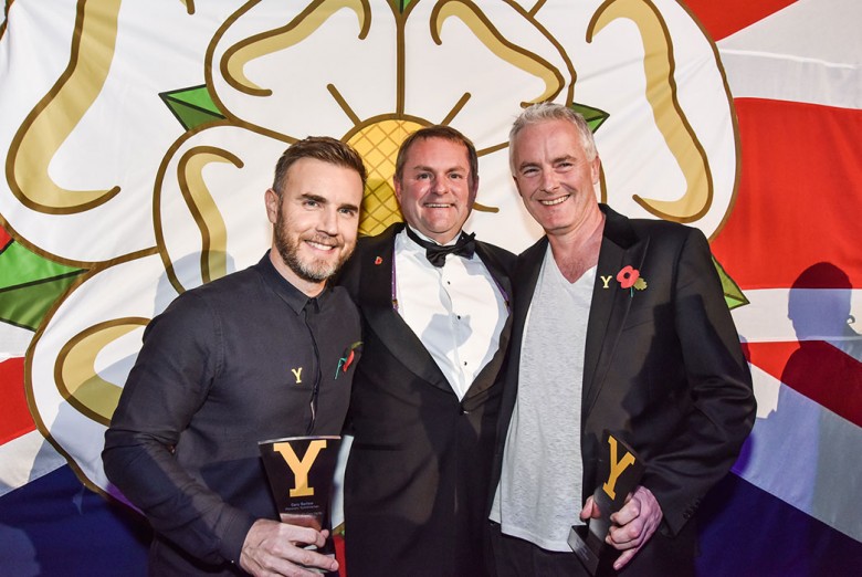 The two Garys, Barlow and Verity, join with Tim Firth in front of a small Yorkshire Rose
