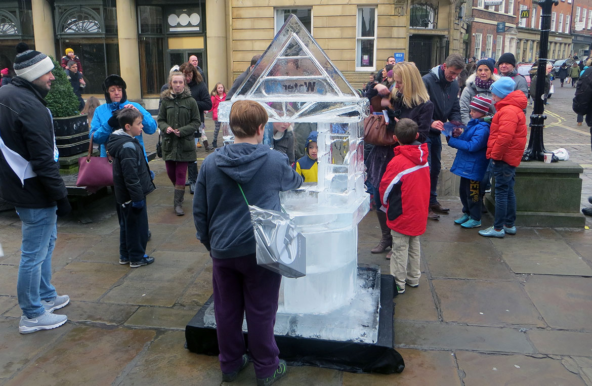Making donations to the wishing well for Water Aid