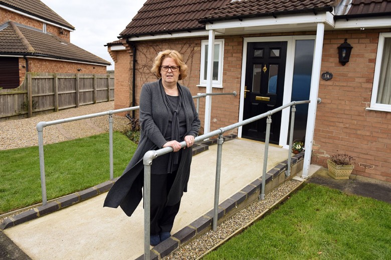 Liz outside their Haxby home, fitted with the wheelchair access ramp