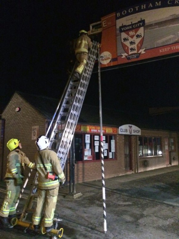 Fire crews fix the sign