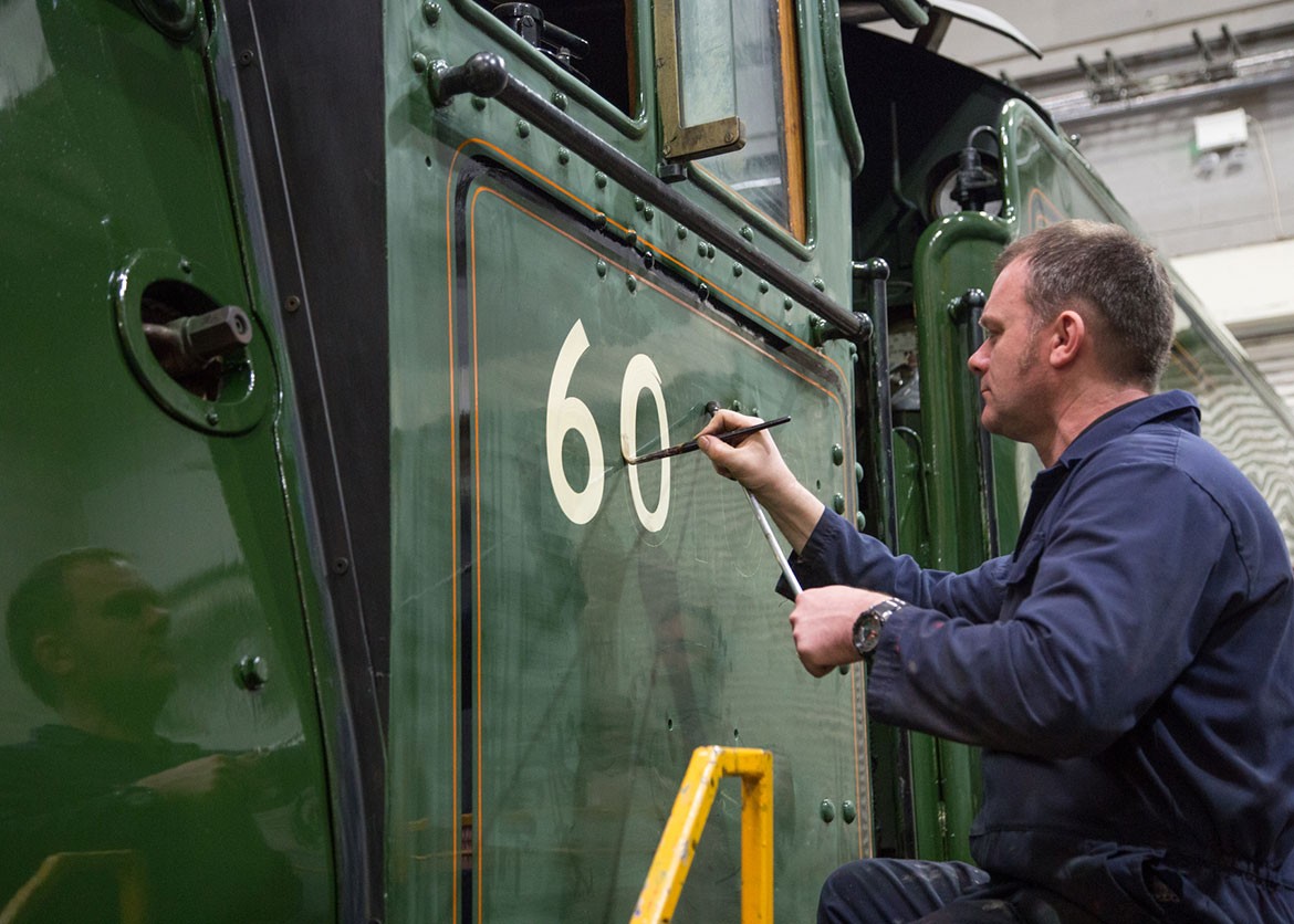 Ian Hewitt paints the number 60103 onto the iconic Flying Scotsman cab. Photograph: National Railway Museum