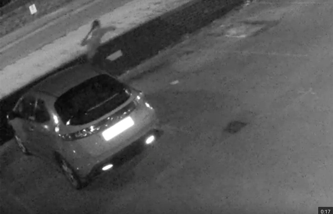 The man throws the object away, in another still from the CCTV