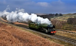 Unfettered by its coaches, Flying Scotsman roars down the track in glorious Yorkshire countryside
