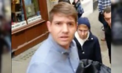 Man hurls foul-mouthed tirade at Purpleman as he collects messages of support for Brussels – video