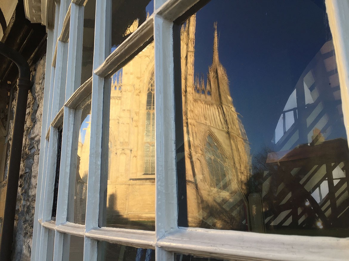 The East Front reflected in the window of St William's College. Photograph: Richard McDougall