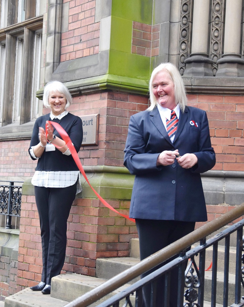 A smile after the ribbon-snipping duty is done