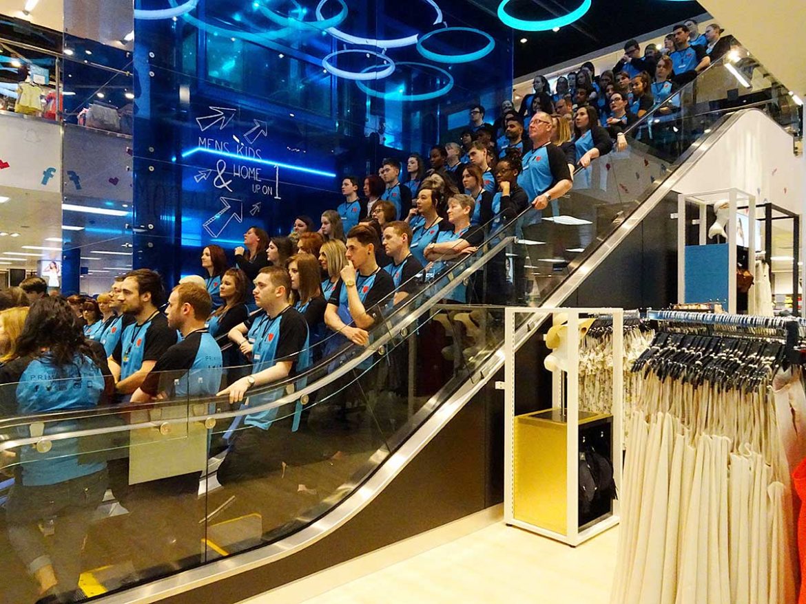 Staff line up for the opening on the escalators