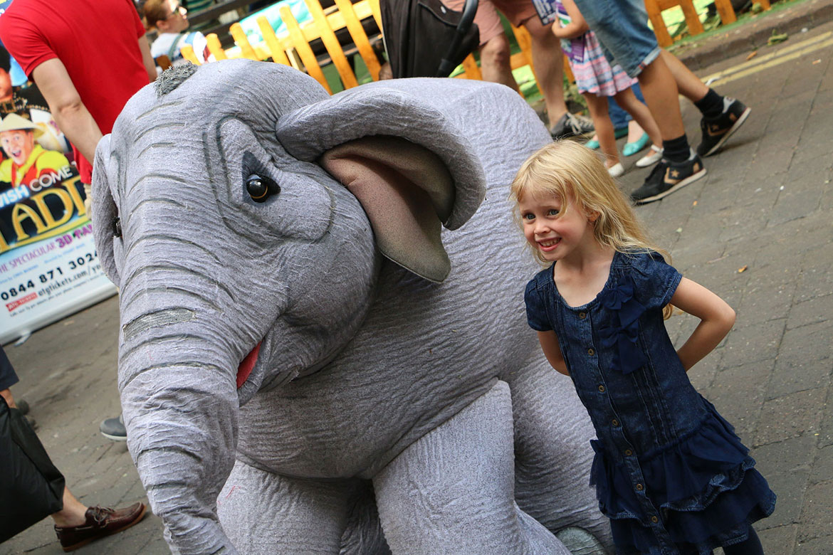 A young girl meets the baby elephant