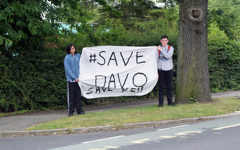 Two young people with the banner