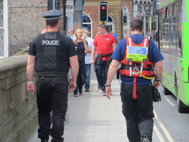 A police officer and member of the Rescue Boat team on Ouse Bridge