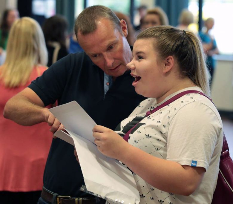 Chloe Stead, the first baby born in the new millennium, picks up her results from York High School head David Ellis