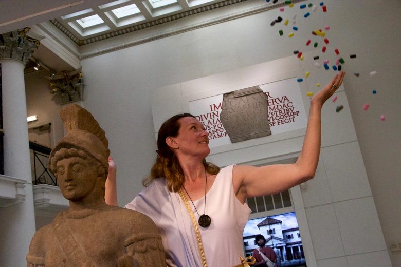 Emma King, dressed as a Roman, steps under a shower of maize pellets. Photograph: Richard McDougall