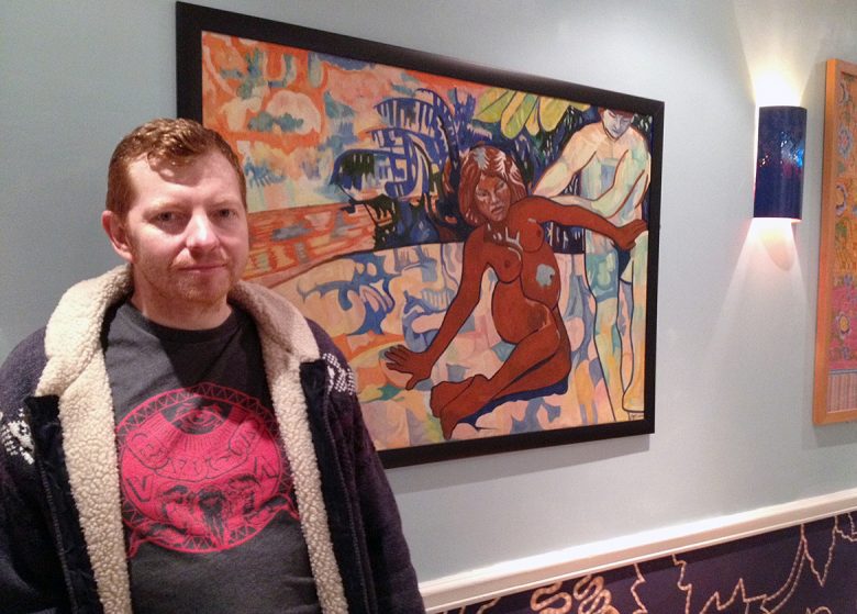 Tim Potter in the restaurant with his painting Two Nudes In The Forest