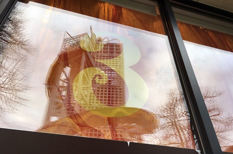 The helter-skelter in King's Square is reflected in the window of York's Chocolate Story, who are due to reveal their design on December 3