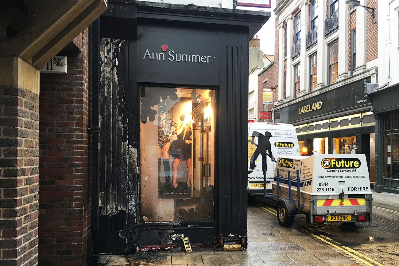 Shop damaged after doorway set on fire