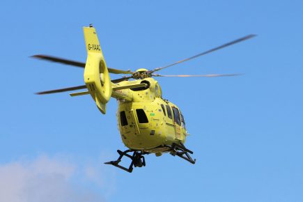 Biker trapped under caravan after crash