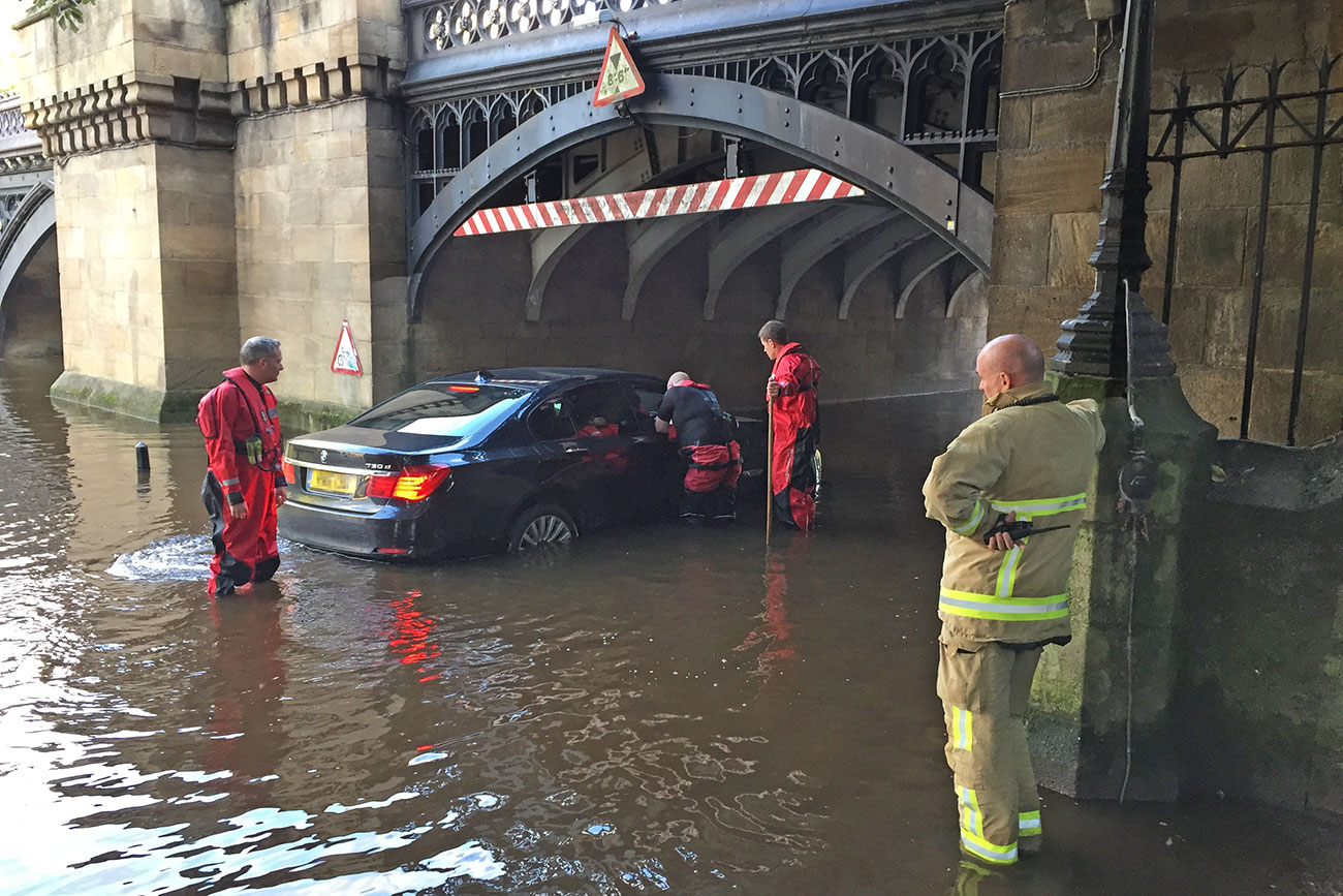 Updated: Two elderly people – and a dog – rescued from car stuck in floodwater