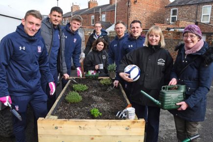 York City players dig in to help create a community garden