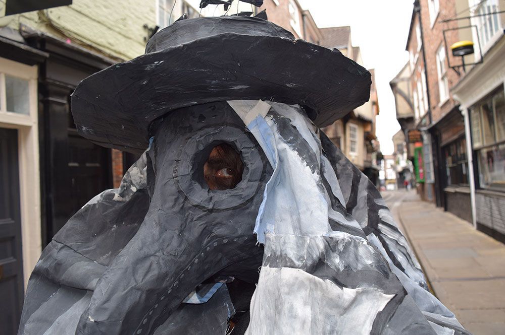 Plague doctor with mask and four-metre cape stalks the streets of York