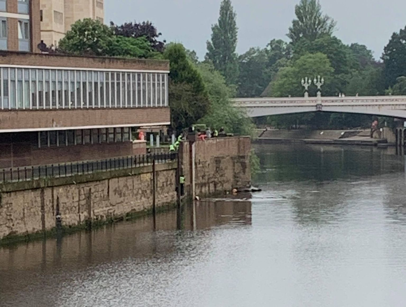 Police officers go into the River Ouse to rescue a man who was in the water