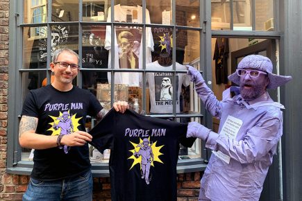 You’ve seen the man, now buy the T-shirt! Purpleman merch goes on sale