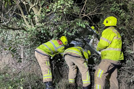 Driver rescued after his car leaves the road and gets wedged in a tree
