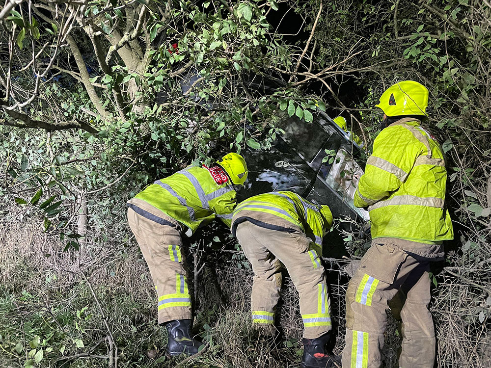 Driver rescued after his car leaves the road and gets wedged in a tree