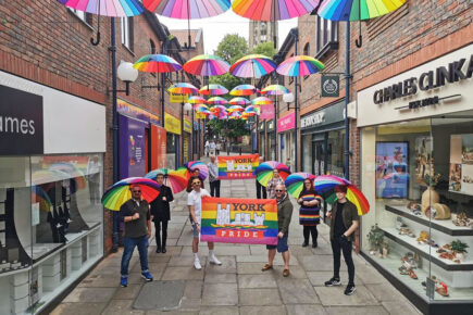 Rainbow brollies take pride of place over Coppergate