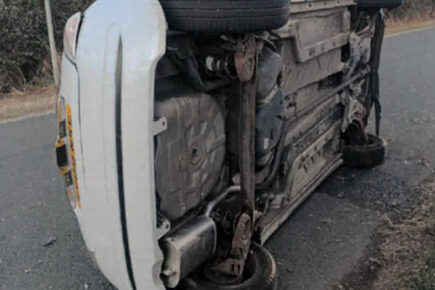 Driver flees after crash leaves car on its side