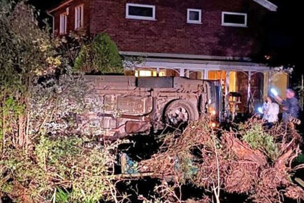 Car crashes into garden and ends up on its side – Driver arrested