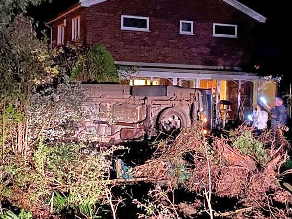 Car crashes into garden and ends up on its side – Driver arrested