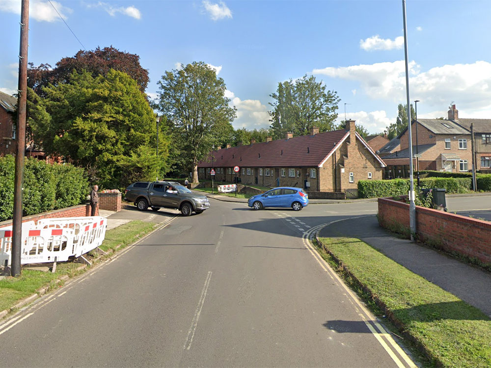 Car crashes into wall in York, narrowly missing woman