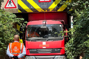 Pictures: Royal Mail wagon gets stuck under railway bridge