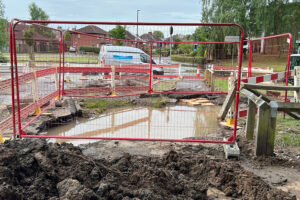 A big hole, a school closed and a road shut: Clear-up begins after the flood