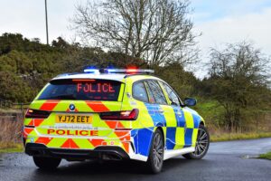 A woman has died after a collision involving bus and car