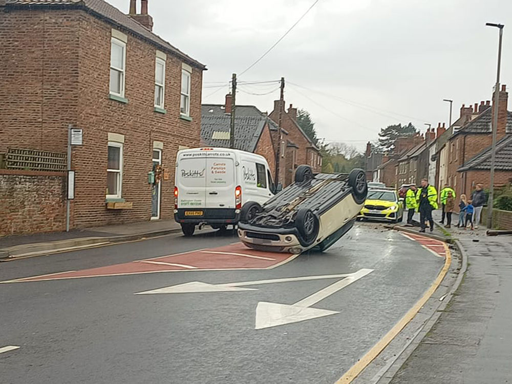 Car ends up on its roof after crash in North Yorkshire village