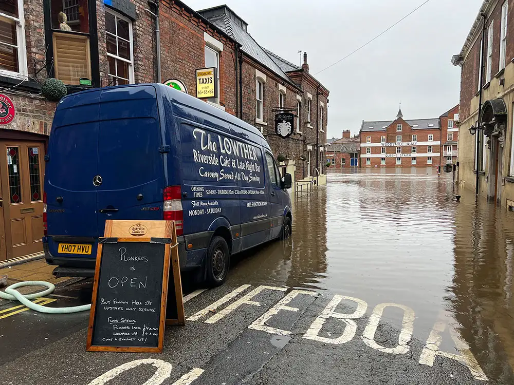 ‘Floody hell, it’s upstairs only’: Flood-hit York bar stays open and urges people to visit