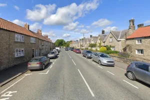 Woman stuck between wall and garden fence rescued by firefighters