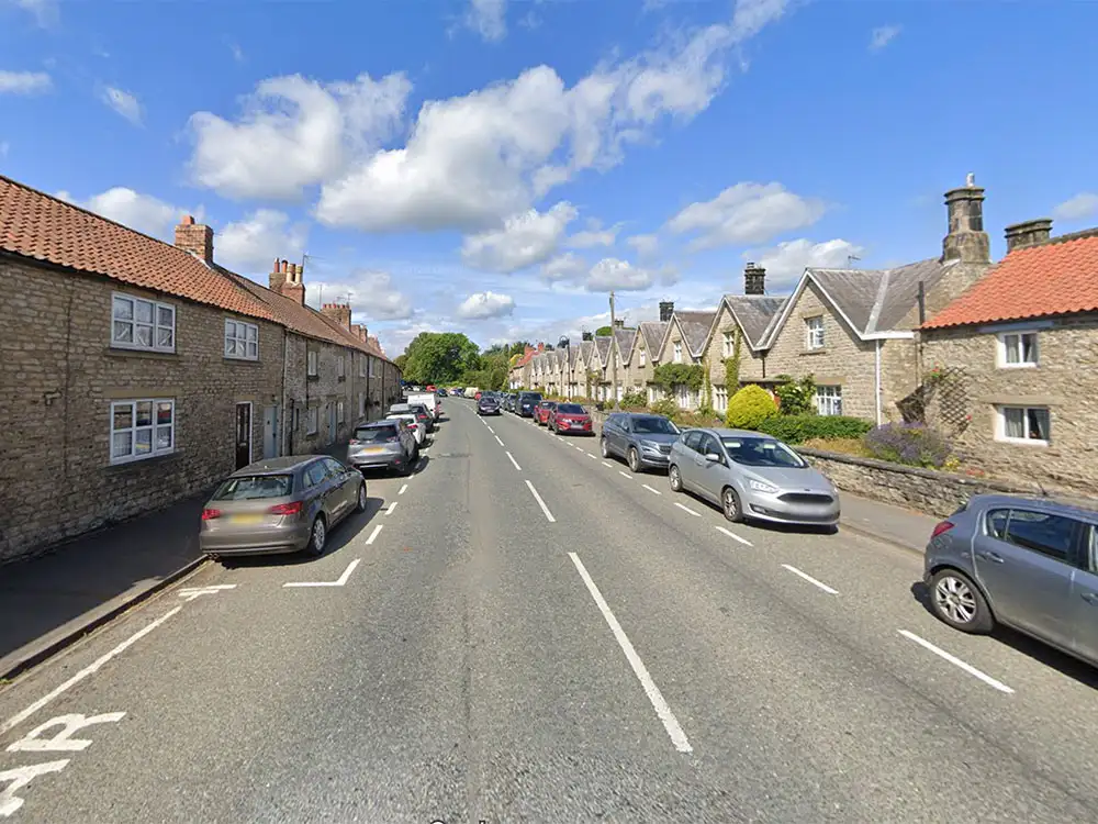 Woman stuck between wall and garden fence rescued by firefighters