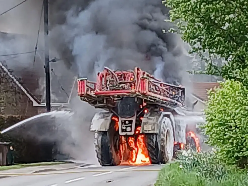 Farm vehicle bursts into flames and closes road