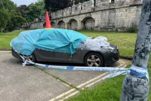 Smashed up car taped off by police near York city walls