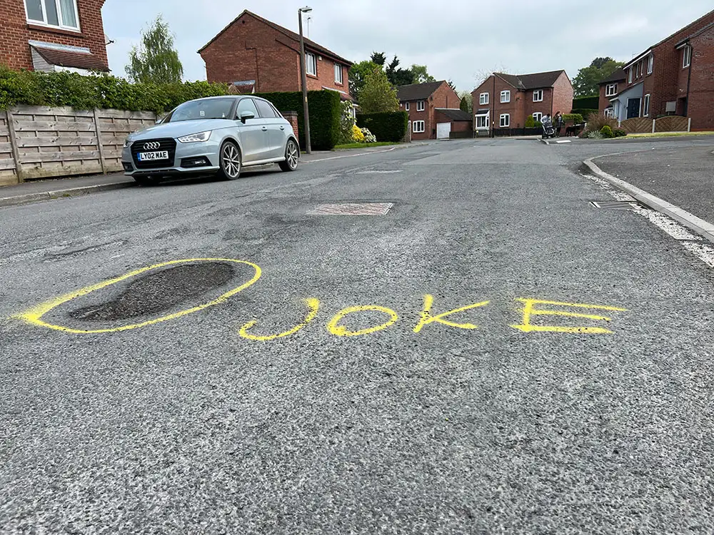 ‘Fill me!’ Mystery graffiti artist highlights potholes on York street