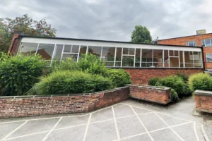 York school wants new fence to stop racegoers urinating on its property