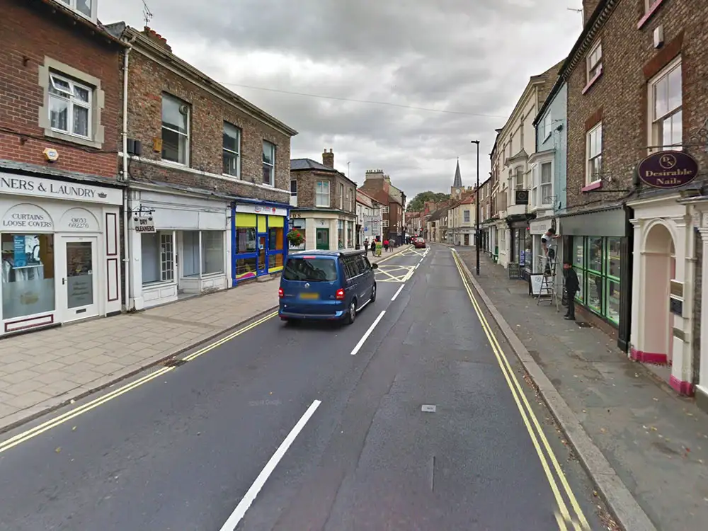 Firefighters respond to smoke billowing out of a shop in Malton