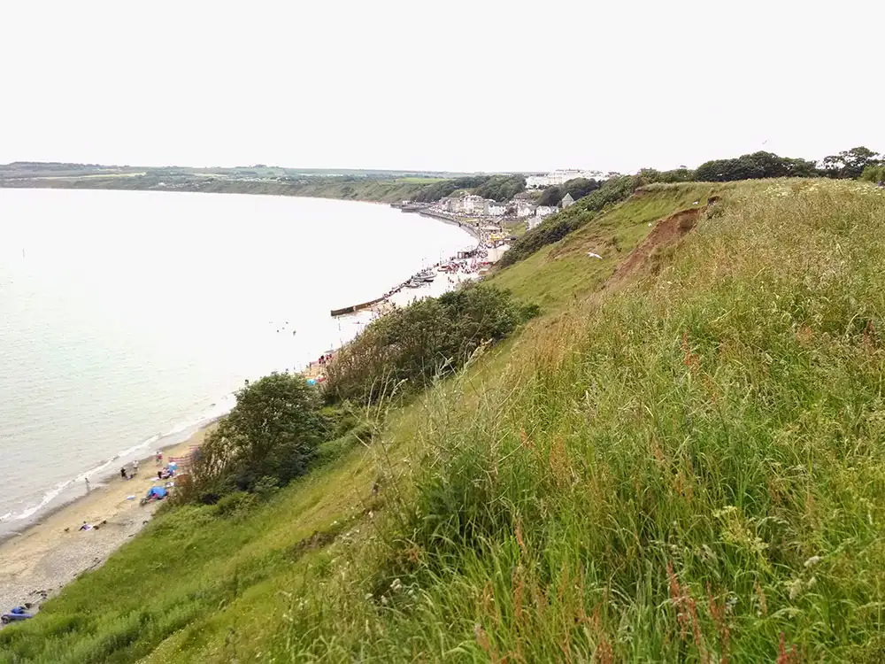 Youths throw bottles off cliff nearly hitting families on popular beach